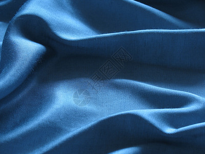 蓝丝绸背景摘要蓝色曲线柔软度纺织品材料折叠背景图片