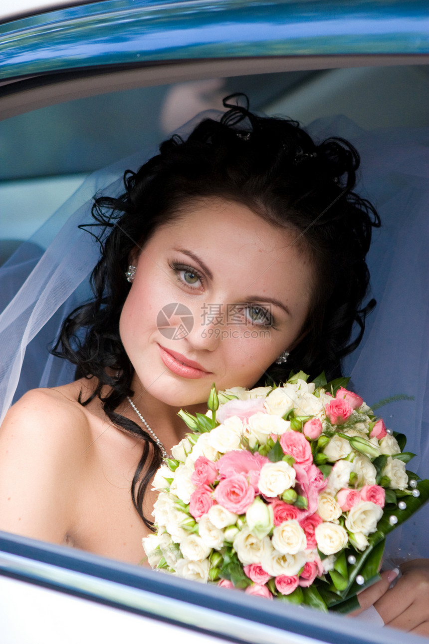 新娘在婚礼车里的肖像玫瑰花束车辆微笑婚礼裙子幸福女孩面纱女士图片