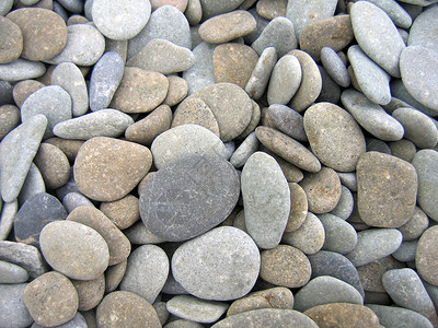 佩布灰色鹅卵石椭圆形卵石圆形石头背景图片