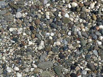 石头在水中太阳清水海滩杂色背景图片