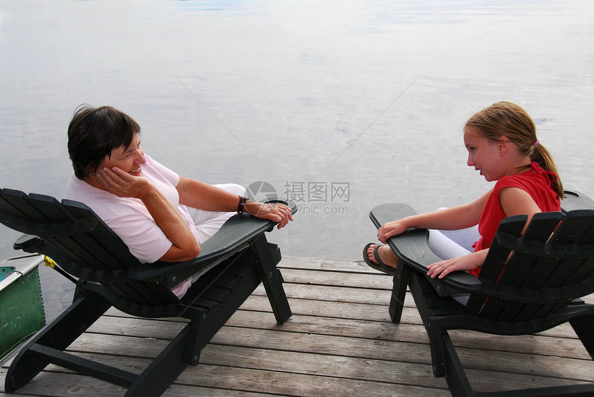 家庭在码头成人退休童年假期椅子祖母女孩女性反射讲话图片