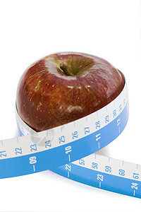 红苹果和磁带测量量卷尺水果食物背景图片