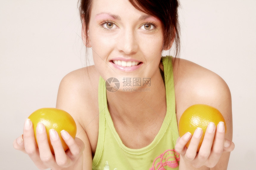 年轻女子维生素乐趣橘子女性微笑图片