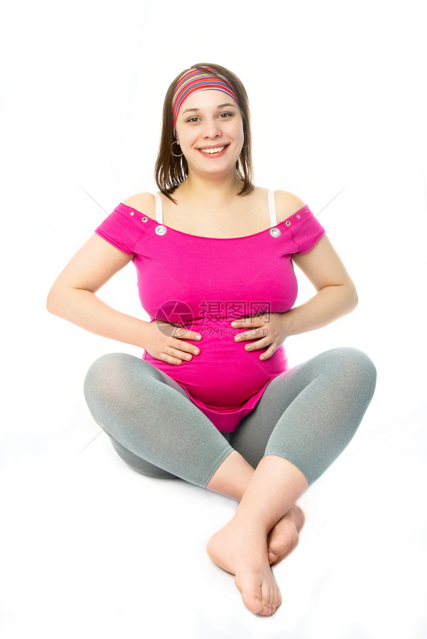 快乐的孕妇母亲腹部幸福婴儿粉色地面父母母性生活裙子图片