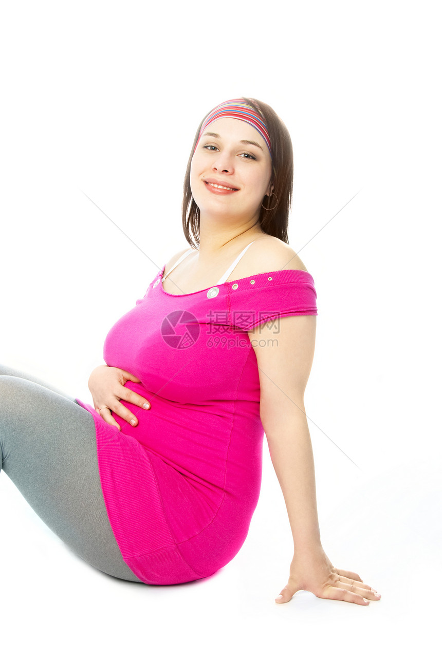 快乐的孕妇微笑地面裙子女性化生活喜悦粉色腹部白色女孩图片