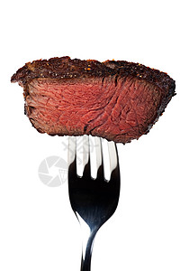 在叉子上烤牛排的一块块棕色食物银器味道牛肉白色营养刀具金属背景图片