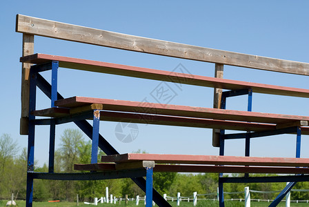 沥滤器长凳金属看台木头学校蓝色运动座位天空晴天背景图片