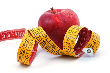 苹果和白色的测量胶带减肥饮食活力控制疾病腰部生活红色食物水果背景图片
