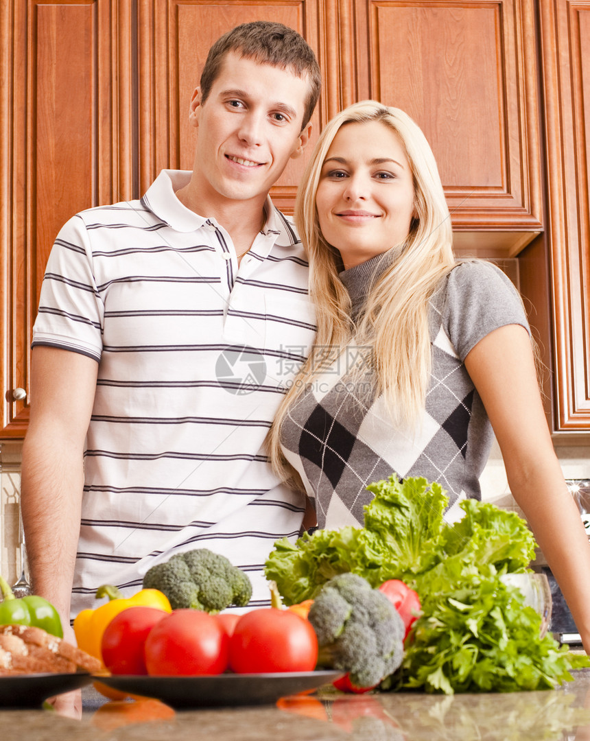 年青夫妇在厨房玩伙伴蔬菜台面低角度营养丈夫幸福头发女士男人图片