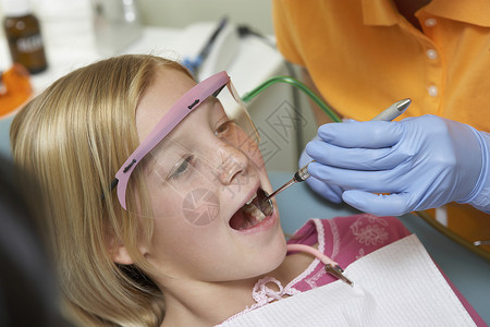 女孩接受牙科检查女孩们机构孩子们牙齿职业口腔牙科医生劳动设施牙医背景图片