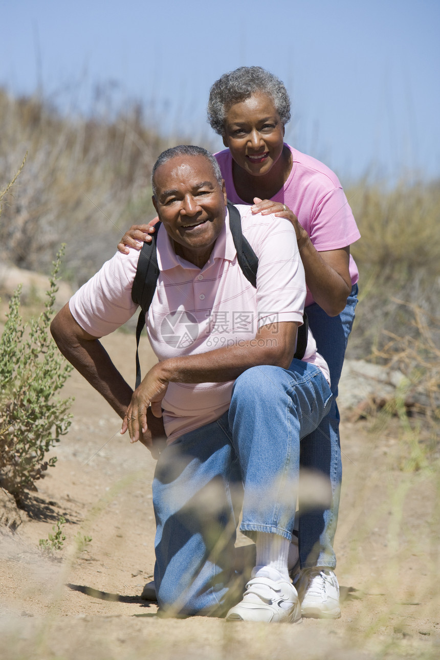长辈夫妇在步行的足迹上水平背包喜悦男性夫妻欢乐快乐男人相机图片