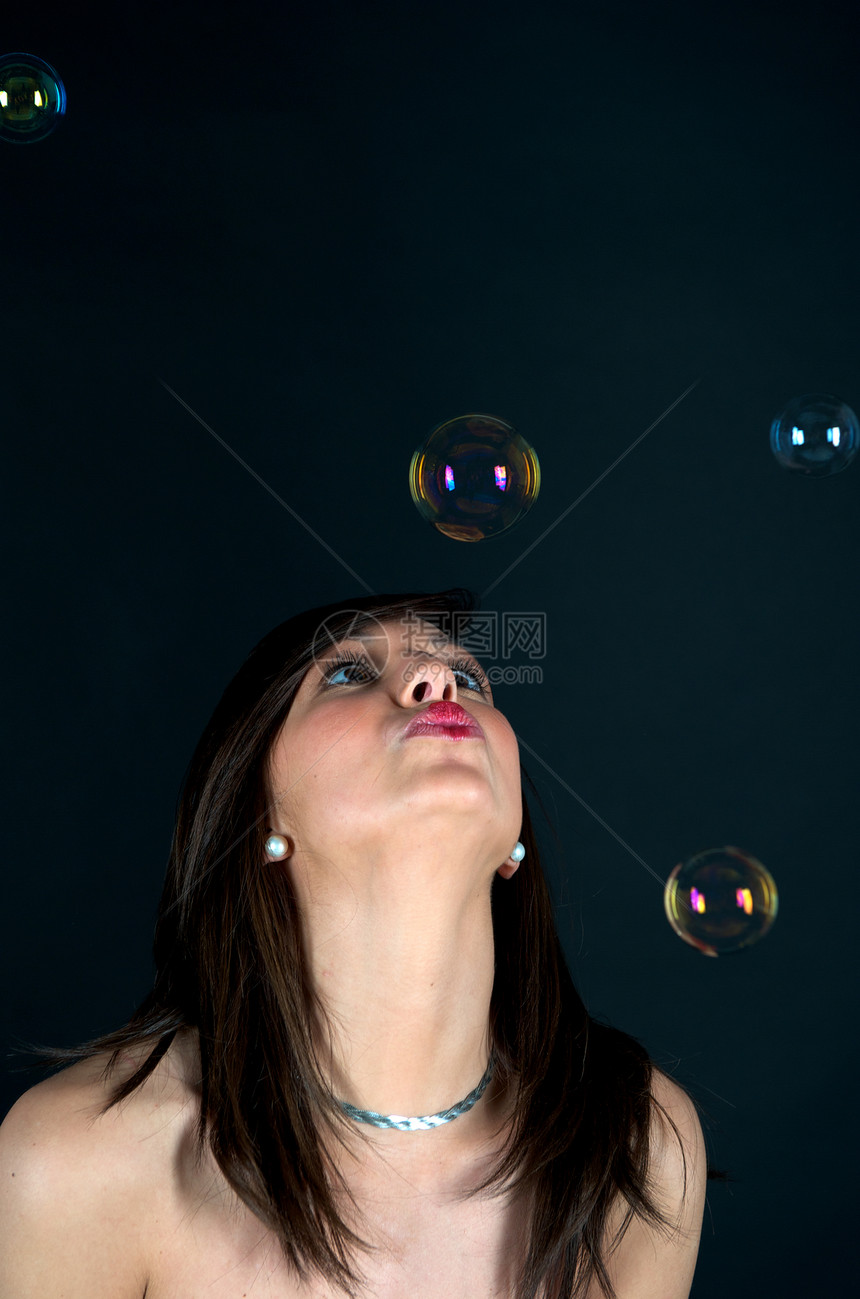 在有泡泡的演播室里的漂亮女人游戏魅力女性工作室气泡肥皂空气幸福头发飞行图片