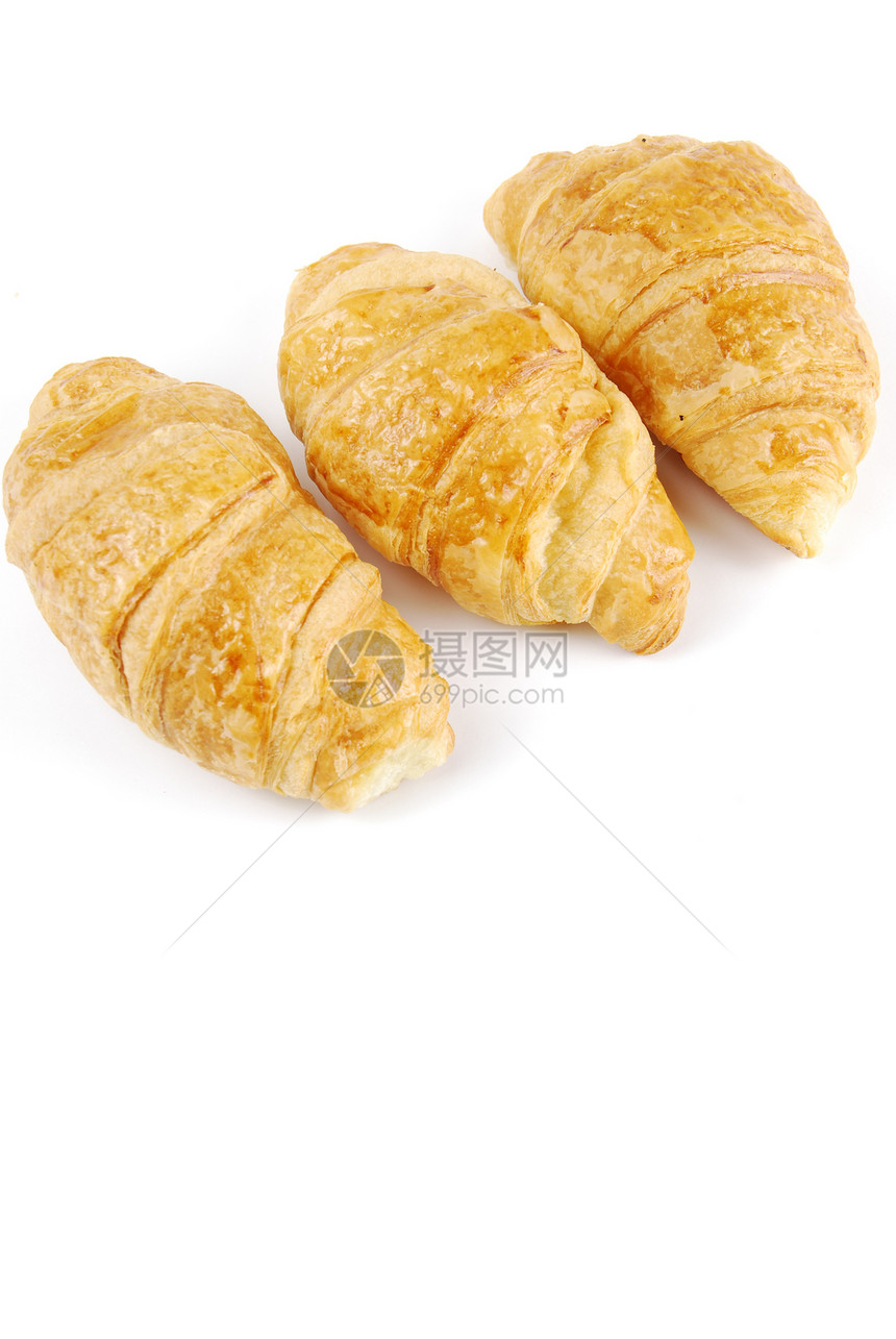 三个新鲜的羊角面包小吃早餐糕点包子白色棕色脆皮金子片状面团图片