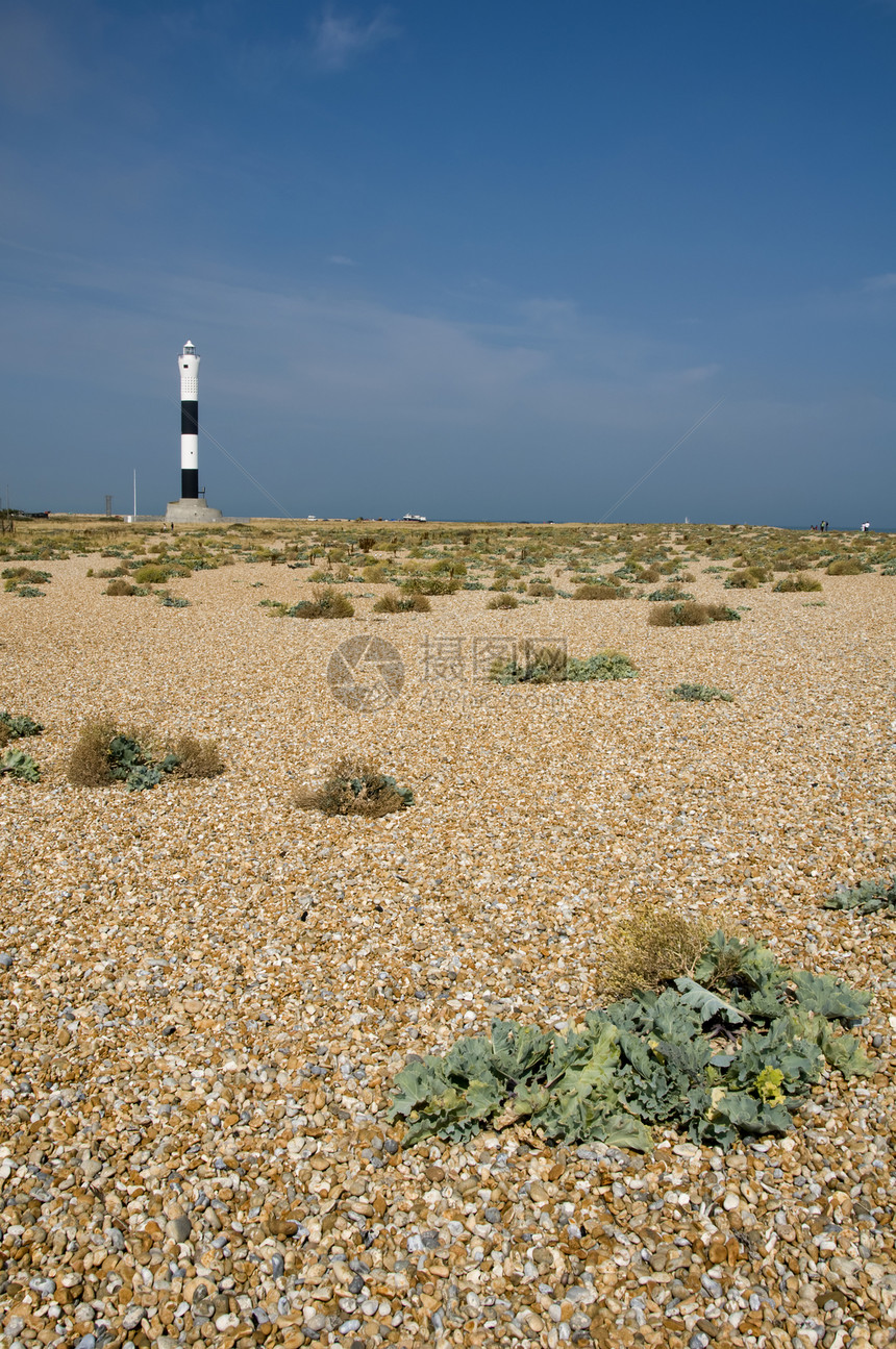 灯塔圆形植物危险蓝色黑色海岸卵石海滩警告白色图片