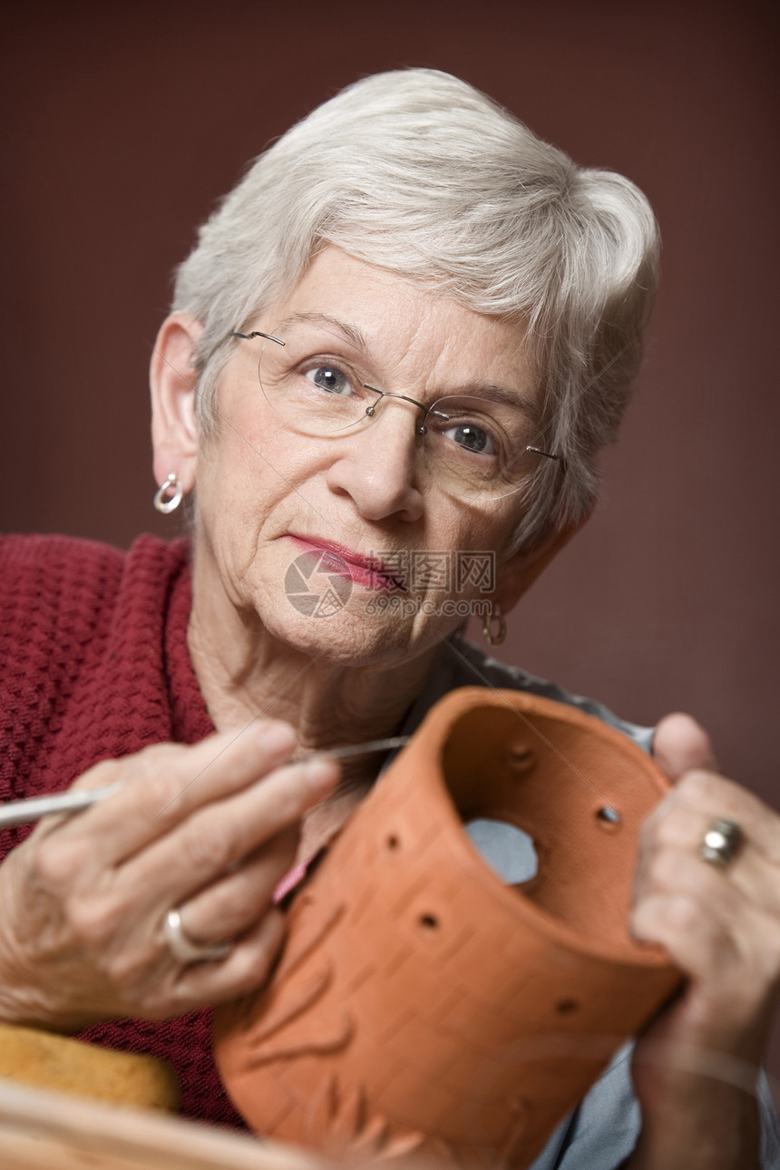 与泥土合作的妇女工具灰色女士手工陶瓷创造力陶器女性雕塑家黏土图片