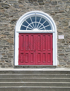石墙上的红色门宗教楼梯石头脚步白色水泥入口教会背景图片