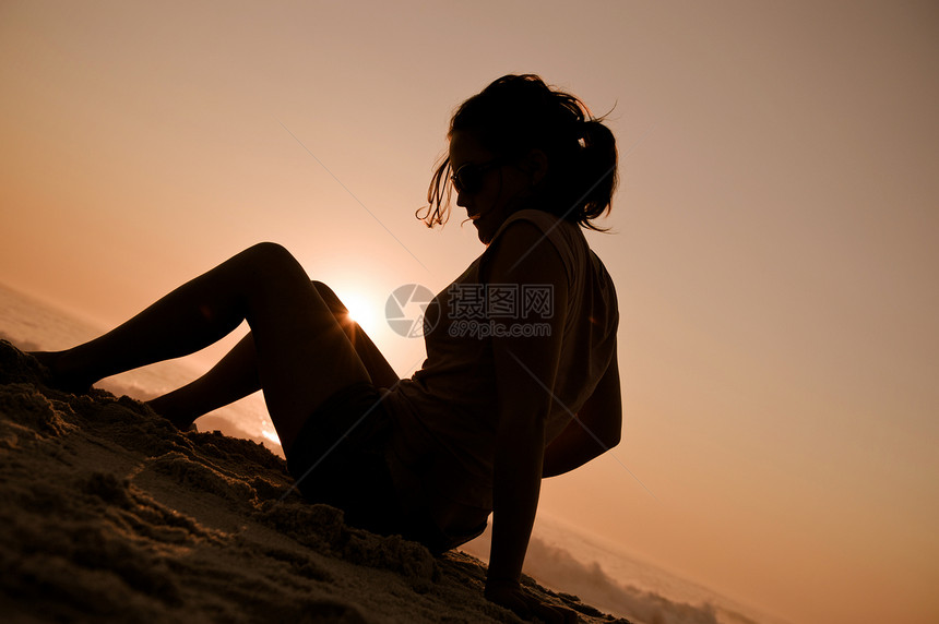 女孩在海滩上闲暇海洋阳光假期太阳女性活力日落波浪女士图片