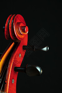 黑色背景的大提琴乐器旋钮旋律音乐曲线背景图片