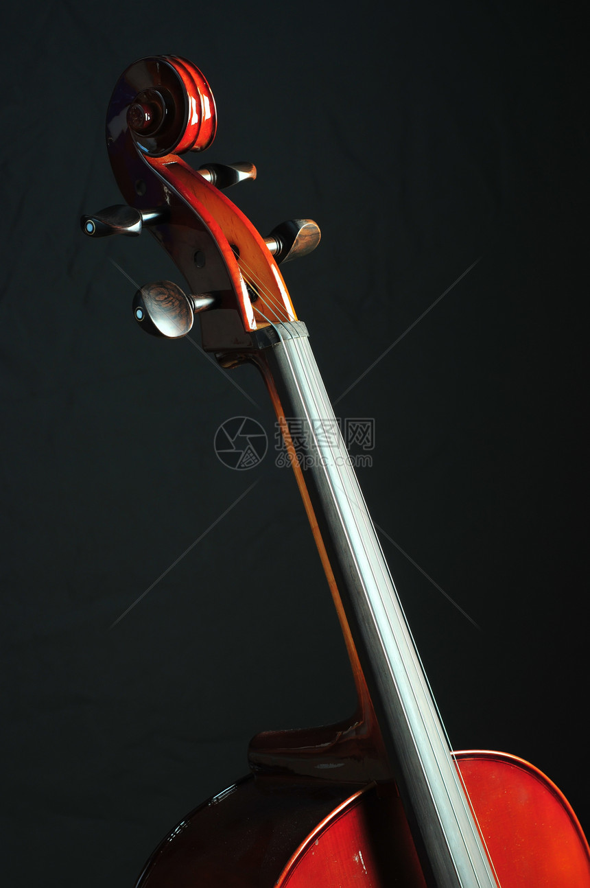 黑色背景的大提琴曲线乐器音乐旋律旋钮图片