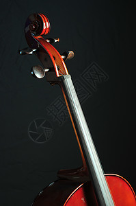 黑色背景的大提琴曲线乐器音乐旋律旋钮背景图片