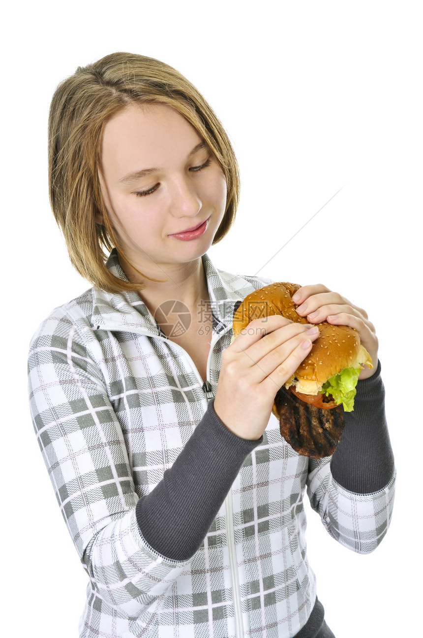 年轻女孩拿着大汉堡包女孩们牛肉垃圾午餐微笑食物女性脂肪青年油炸图片