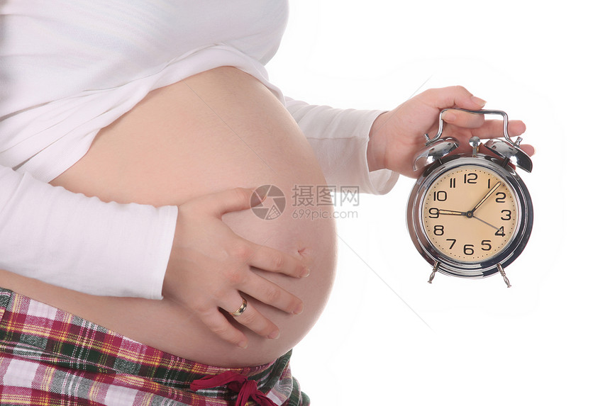 怀孕妇女等待闹钟的时钟图片