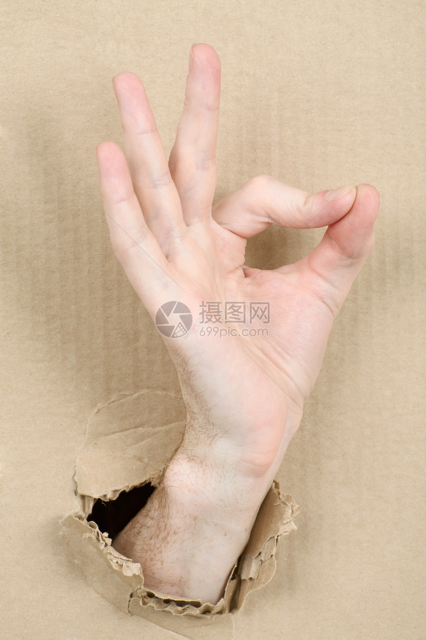 将男性手从纸板上刺穿褐色纸盒男人手势情绪化手指棕色棕榈图片