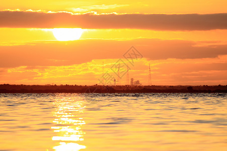 日出时空航天飞机发射台天空日落橙子红色太阳光发射中心软垫太阳背景图片