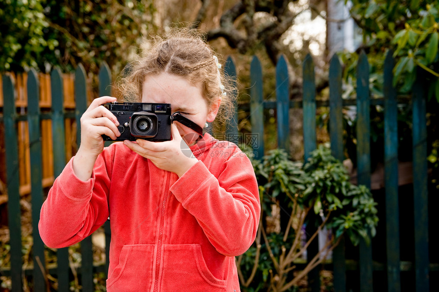 穿红色夹克和照相机的年轻女孩图片