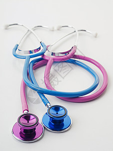 粉色和蓝色听诊器医疗工具女性药品男性医院乐器测试背景图片