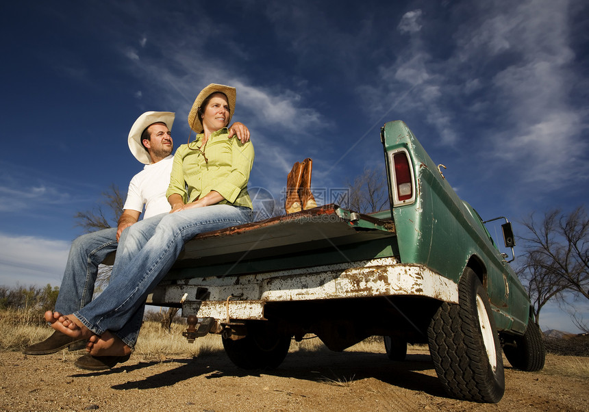 牛仔和骑小货车的妇女牛仔裤靴子帽子成人男性汽车赤脚快乐卡车感情图片