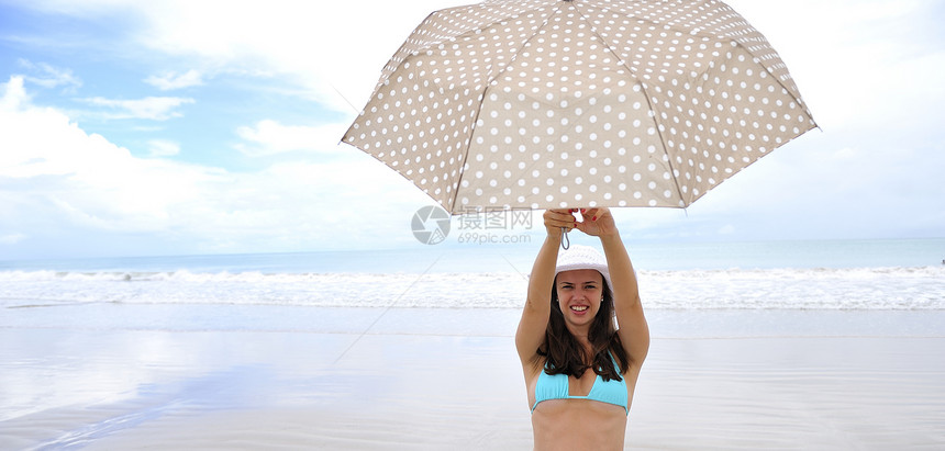 享受海滩阳伞海洋天堂海岸女性比基尼游客旅行假期女孩图片