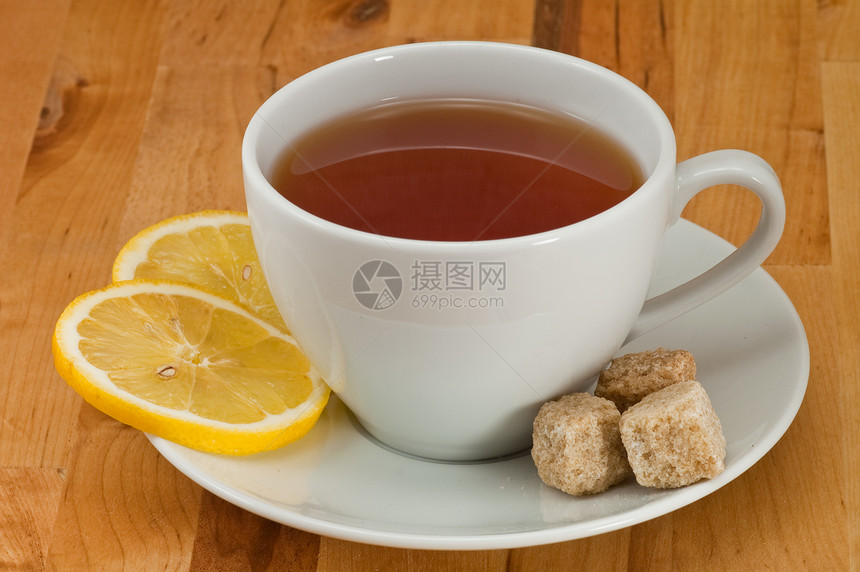 茶和柠檬黑色立方体茶点盘子白色草本黄色棕色杯子桌子图片