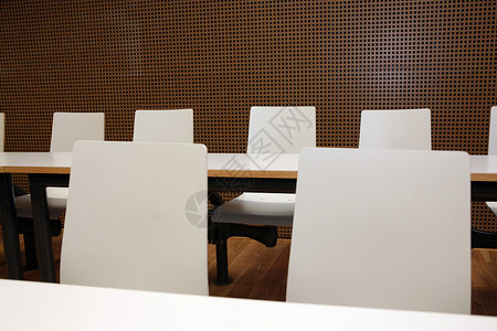 带有白色座位的会议室棕色房间教育工作桌子董事办公室木板公司椅子背景图片
