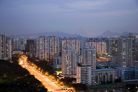 现代城市在夜里变色城市化公寓住宅建筑物夜景景观日落房地产背景图片