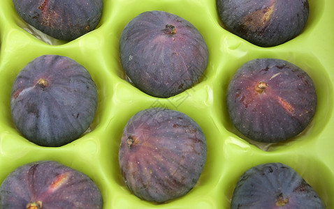 新鲜无花果小吃情调水果生活方式包装健康饮食种子紫色绿色食物背景图片