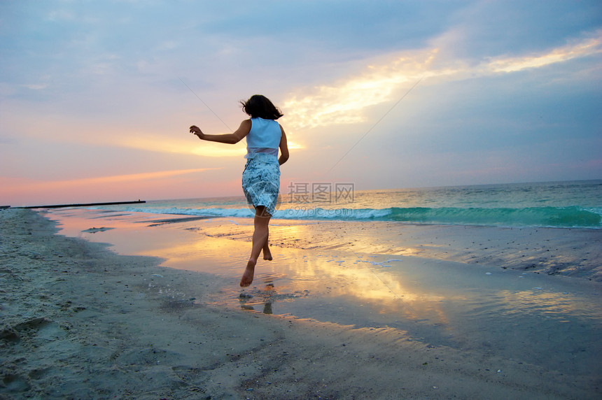 清晨在海边的一个女人天空女性海浪女孩们海洋海岸日落成人海滩太阳图片