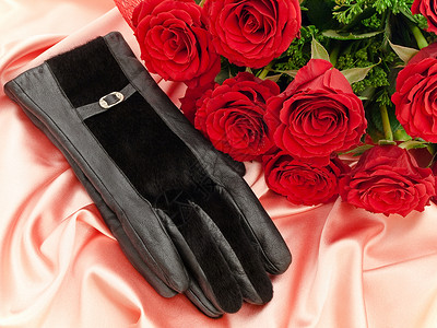 一双棉手套红玫瑰和手套背景