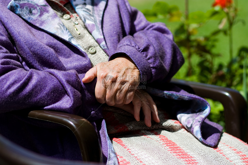 阳光下坐着的老年妇女图片