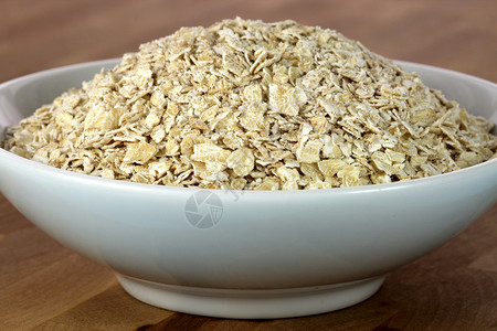 碗里的燕麦片片早餐谷类食品燕麦食物健康饮食背景图片