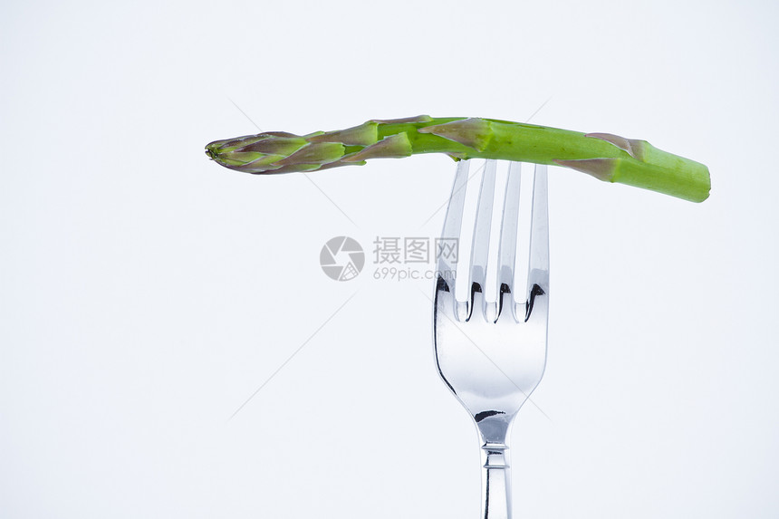 在叉口咬食肉类饮食绿色蔬菜概念食物健康食品维生素营养白色图片