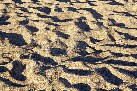 沙棕色海岸海浪二氧化硅粒状地形沙漠热带波纹沙丘背景