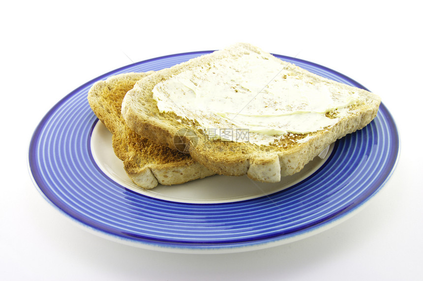 在板块上吐司烘烤紧缩面包营养盘子棕色蓝色早餐食物脆皮图片
