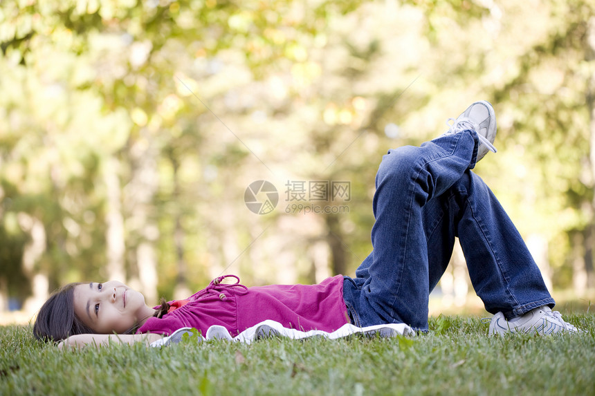 小女孩躺在草地上晴天孩子混血儿混血女孩福利图片