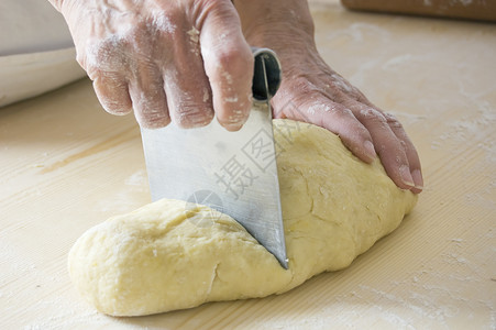 给钱厨房手工面粉蛋糕面包师女人厨师刀具面团面包背景图片