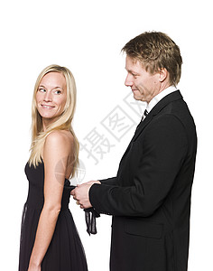 男子帮助妇女穿衣服工作室微笑夫妻连衣裙戏服男性女士老乡套装女性背景图片