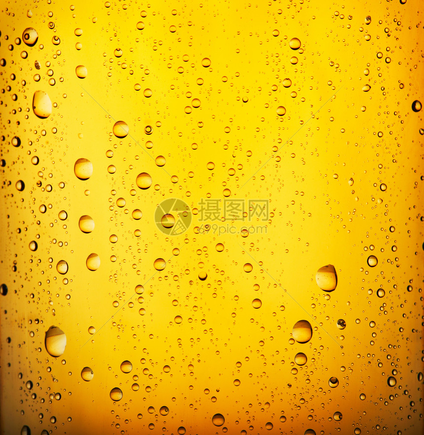 冷啤酒玻璃啤酒厂气泡宏观飞沫金子黄色泡沫液体茶点图片