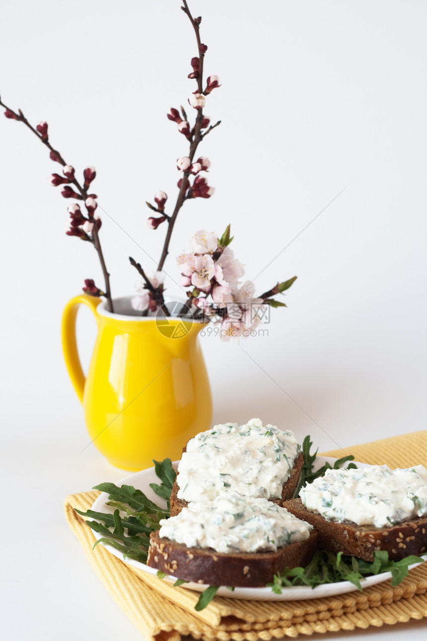 黑麦面包和花束上的奶酪小吃巧克力食物花朵草药黄色产品分支机构餐巾白色绿色图片