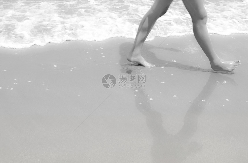 脚在沙滩上行走 黑白相印图片