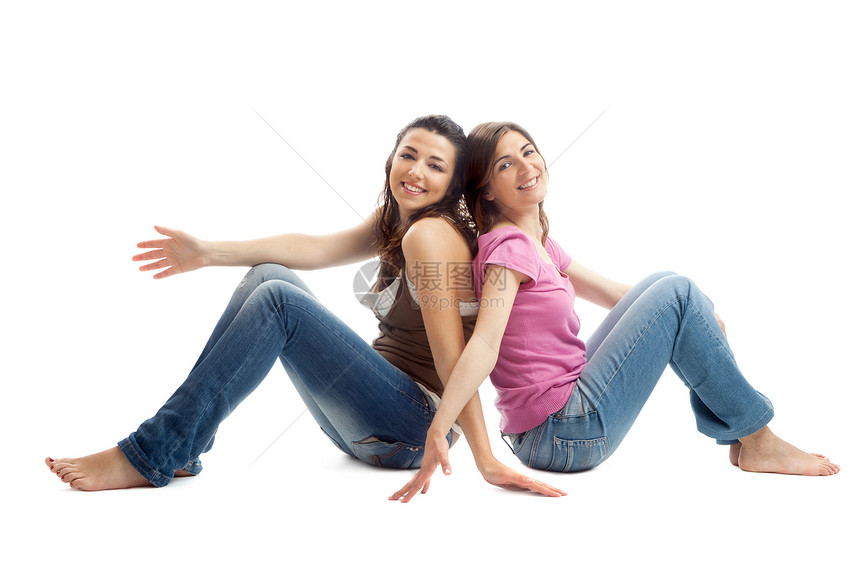 快乐的青年妇女微笑白色美丽青少年女性女士地面牛仔裤幸福冒充图片